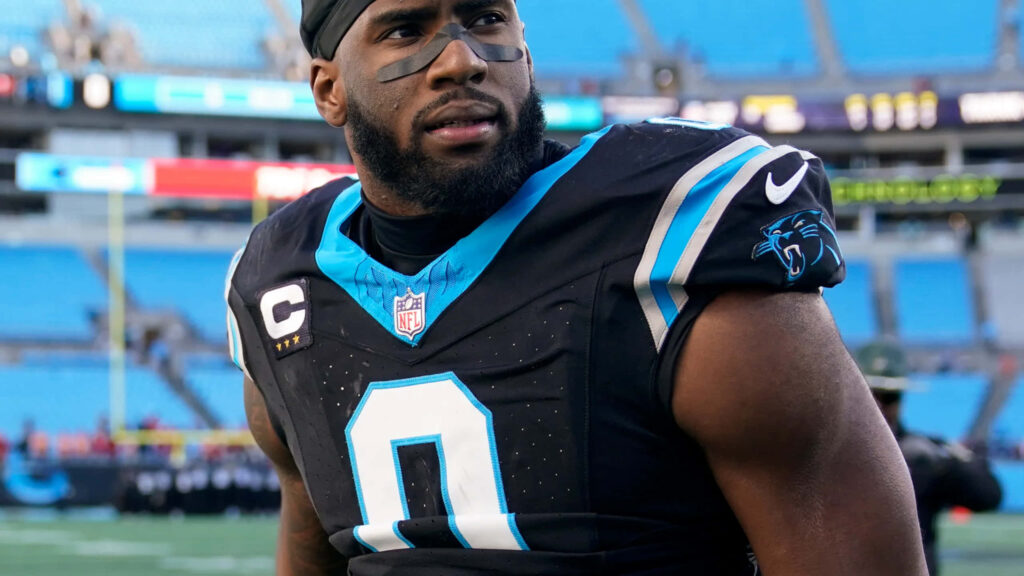 Brian Burns Carolina Panthers NFL player in black uniform with blue accents stadium background wallpaper
