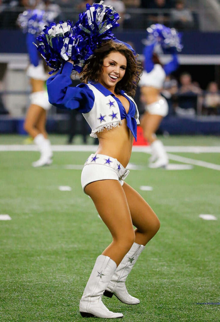 Energetic Cheerleader Wallpaper: Vibrant Outfit & Pom-Poms in Action