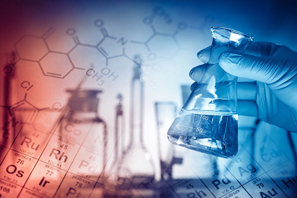 Gloved hand holding flask with clear liquid surrounded by chemical formulas and periodic table background Wallpaper