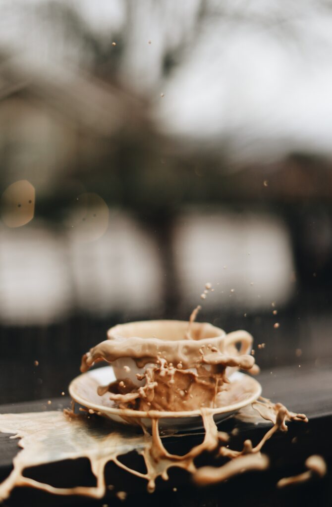 Dynamic Coffee Splash Wallpaper - Mid-Air Action with Cup & Plate