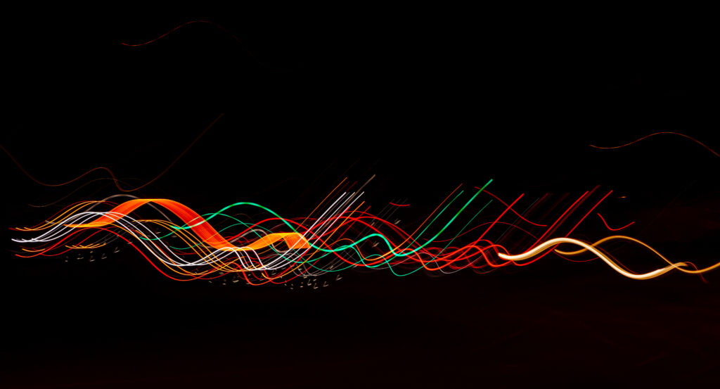 Dynamic Colorful Light Trails on Black Background – Abstract Wallpaper