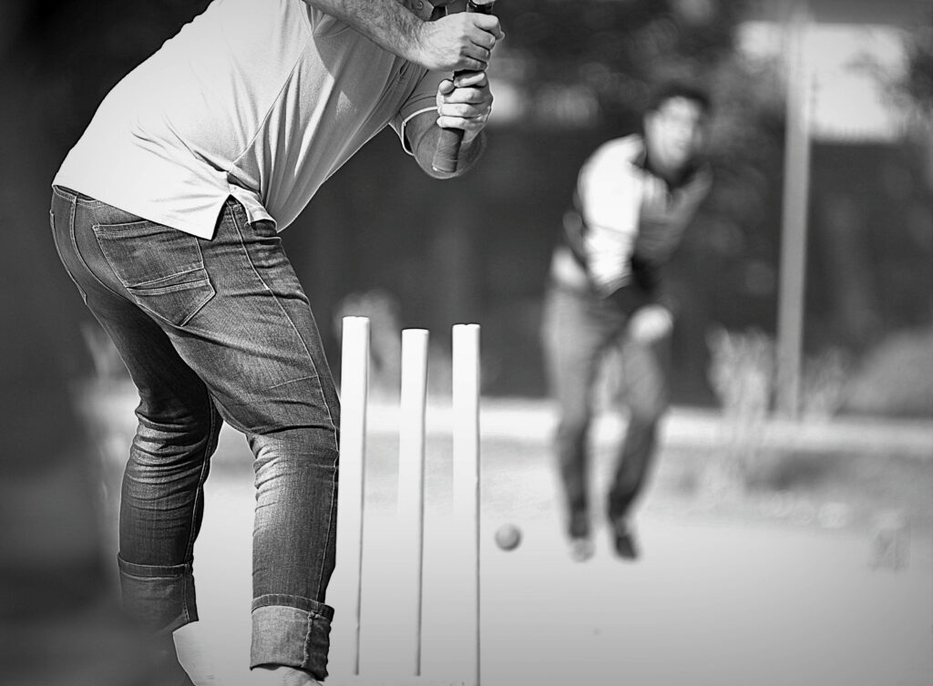 Dynamic Duel in Monochromatic Charm: Cricket Legends Locked in Intense Battle Wallpaper