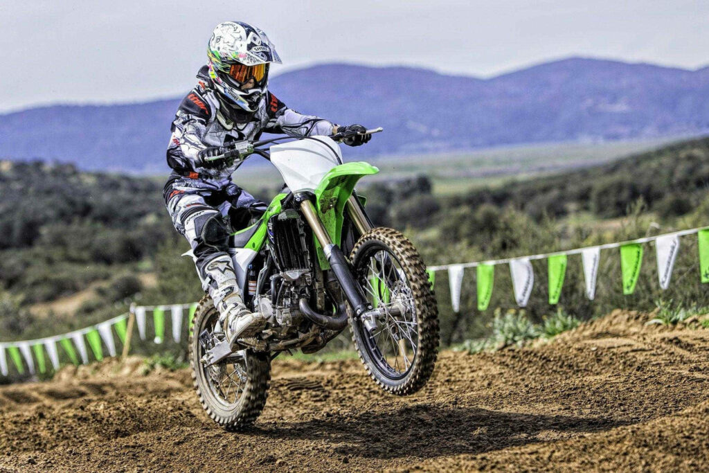 Dynamic Cool Bike Wallpaper: Rider Wheelie on Rugged Trail
