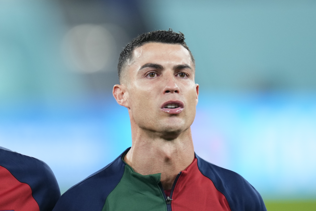 Dynamic Cristiano Ronaldo Wallpaper: Poised Football Icon Background