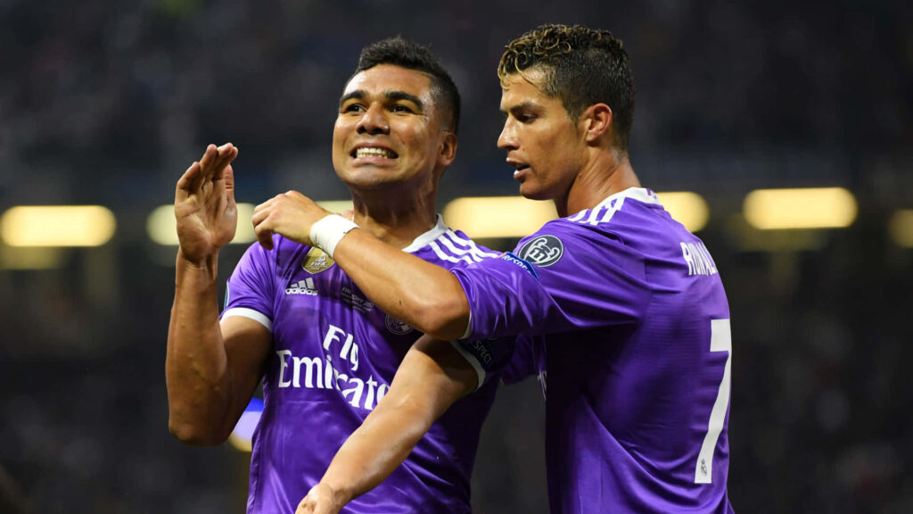 Dynamic Cristiano Ronaldo Wallpaper: Celebrating Teamwork in Action