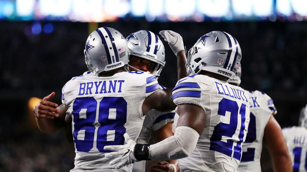 Dynamic Dallas Cowboys Players Celebrating | Team Spirit Wallpaper