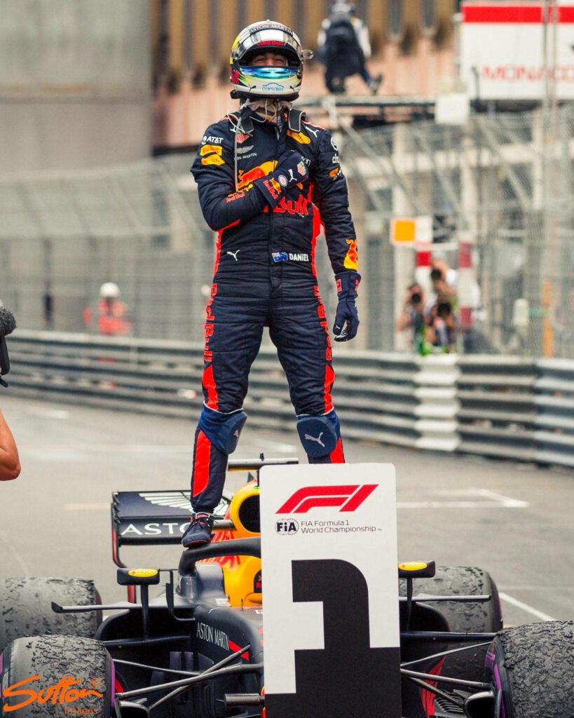 Daniel Ricciardo Celebrates on F1 Car - Dynamic Race Suit Wallpaper