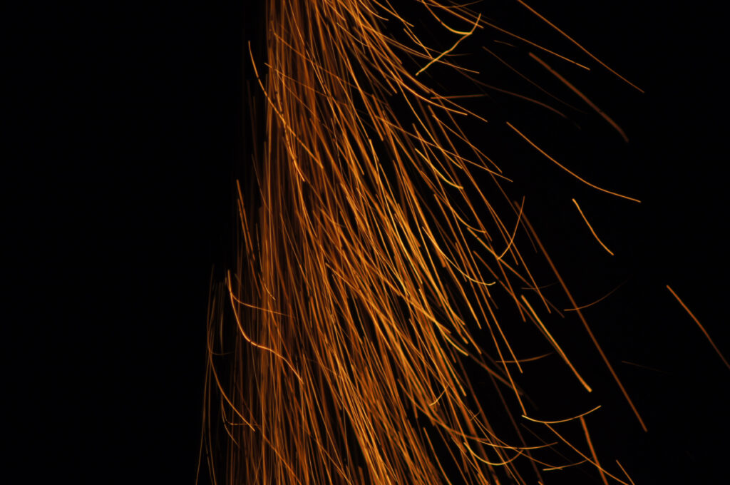 Dynamic Dark Background with Bright Orange Sparks - Abstract Wallpaper