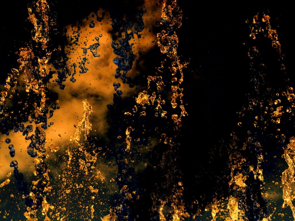 Dynamic Abstract Wallpaper: Fiery Liquid Splashes in Dark Tones