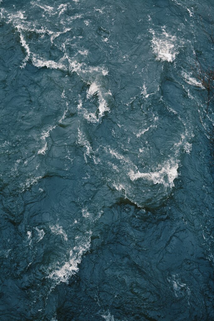 High resolution ocean wallpaper with deep blue waves white foam and natural water ripples