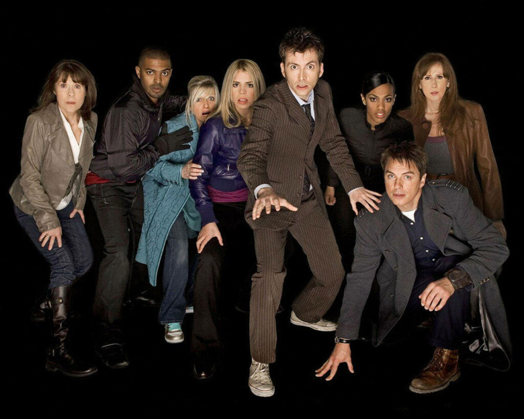 Dynamic Doctor Who Wallpaper: Iconic Cast in Adventurous Poses