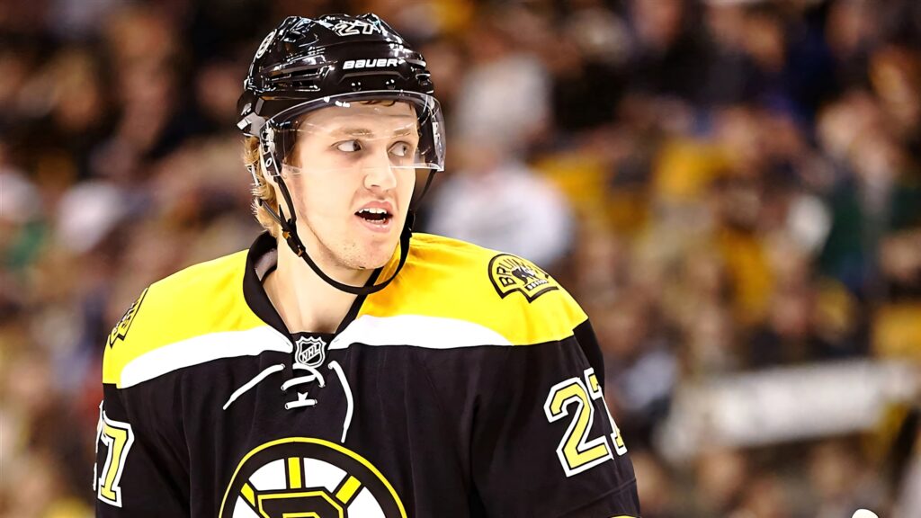 Dougie Hamilton in Boston Bruins jersey fiercely skating during Bruins vs Flyers NHL game wallpaper