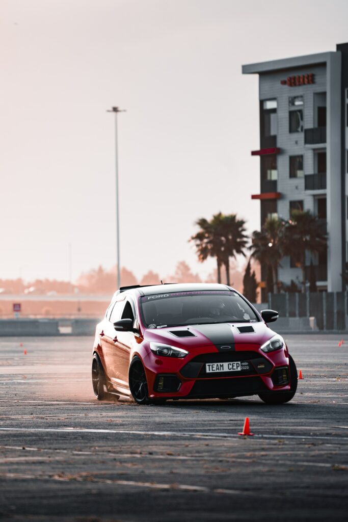 Dynamic Red Car Drift Wallpaper: Urban Action Scene & Performance