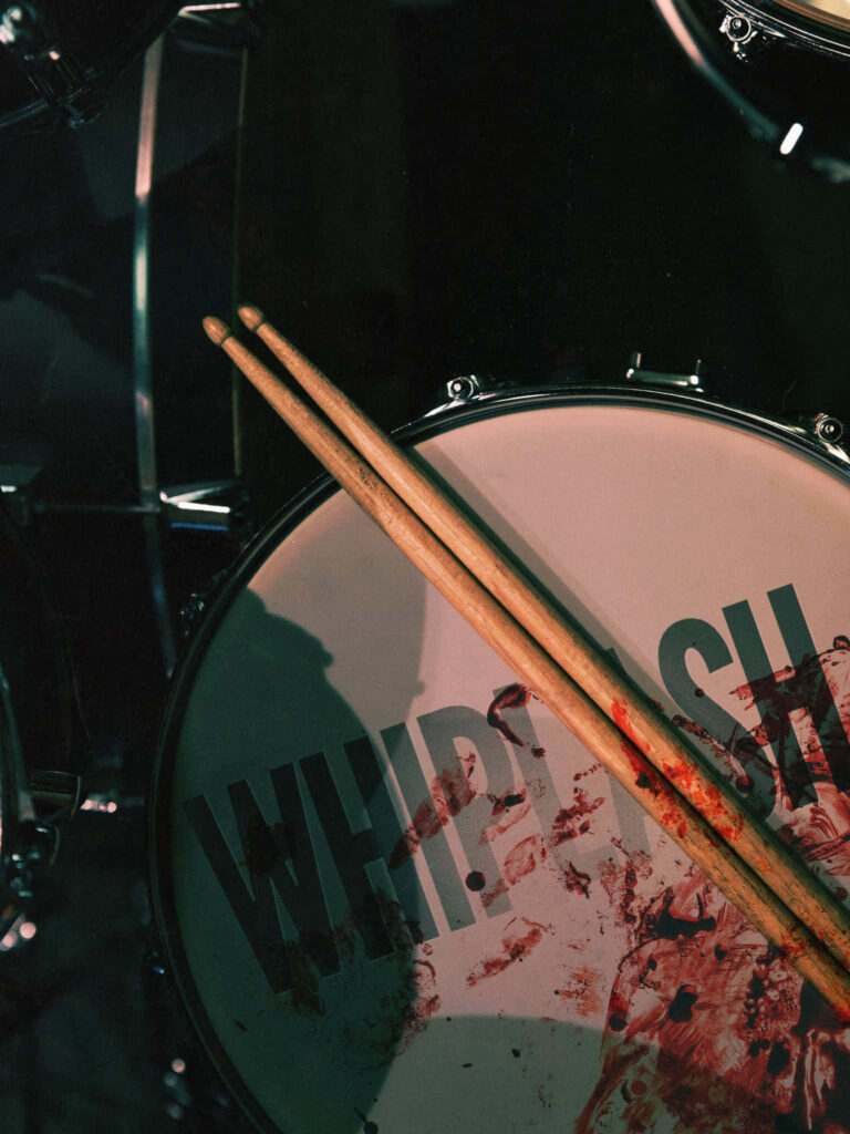 Intense Drumset Wallpaper with Whiplash Logo - Striking Background