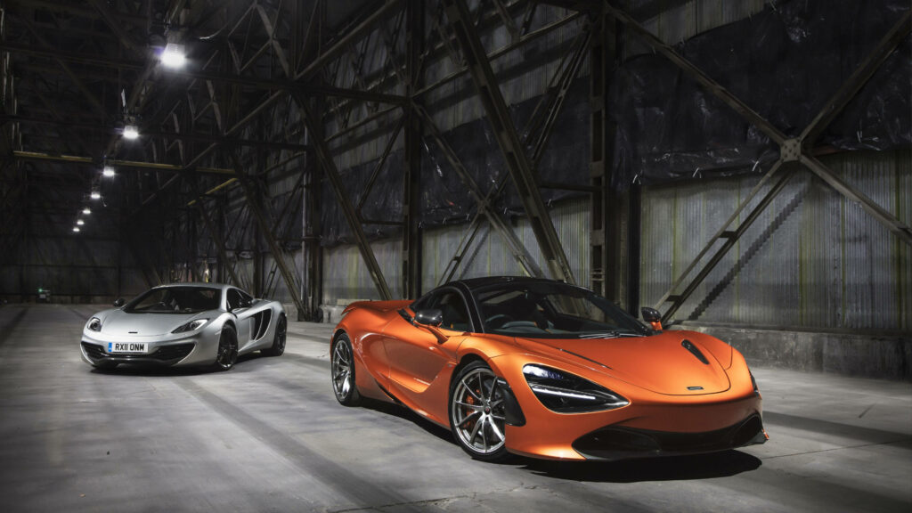 Dual Elegance: Stunning Gray and Orange McLaren 570s Grace a Vast Empty Warehouse Wallpaper