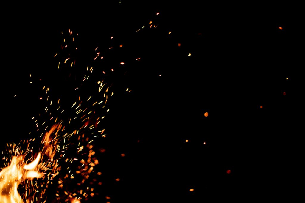 Dynamic Fire Sparks Wallpaper - Vibrant Bonfire Energy Background