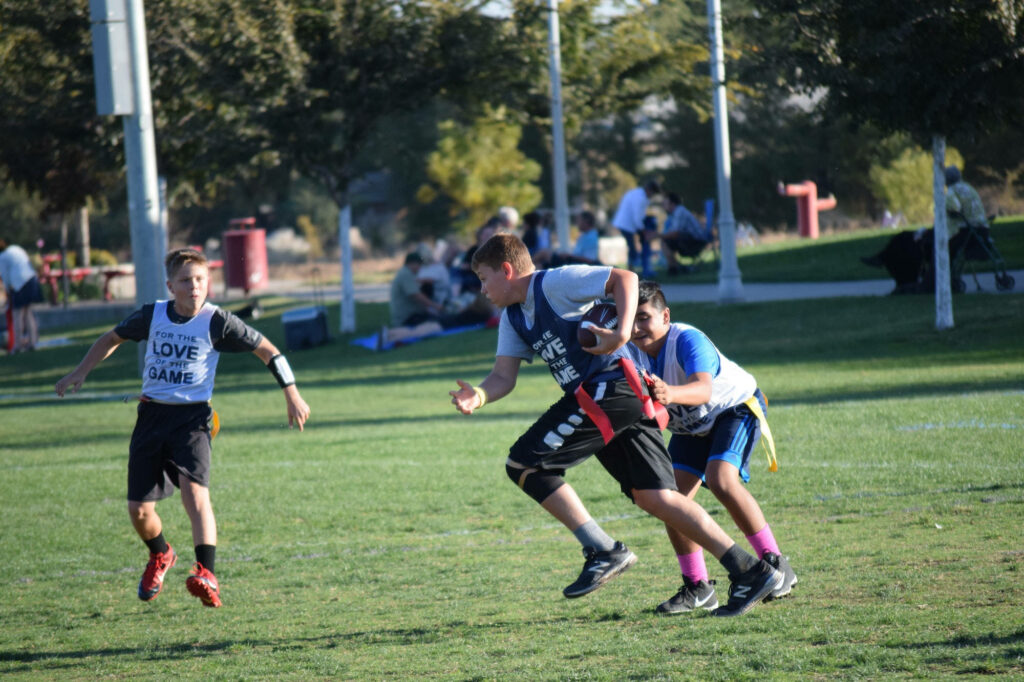 Vibrant Flag Football Match: Young Players in Action - Wallpaper