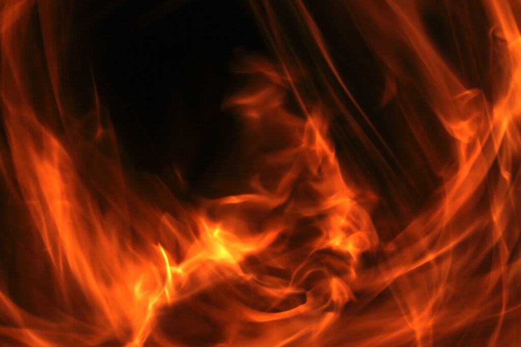 Dynamic Swirling Flames Wallpaper on Dark Background