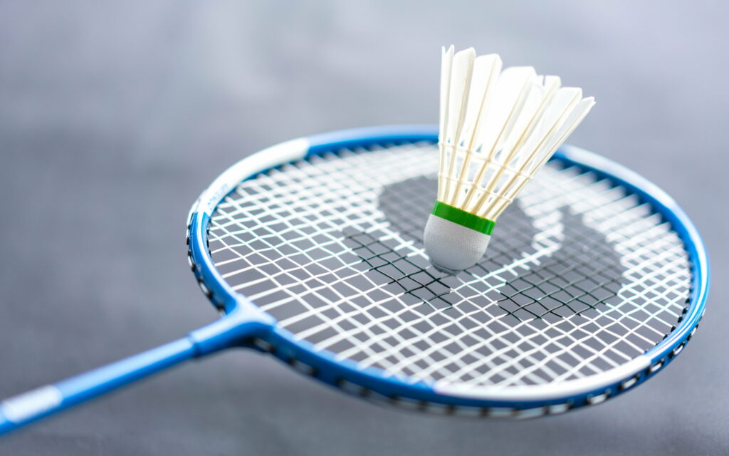 Powerful Shuttlecock: Vibrant Closeup of Badminton Racket Gear | 4K Wallpaper