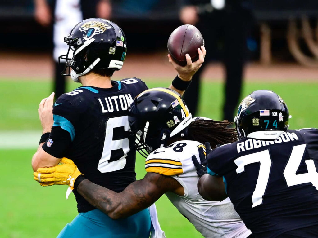 Dynamic Bud Dupree Tackle Wallpaper: Intense Football Action Background