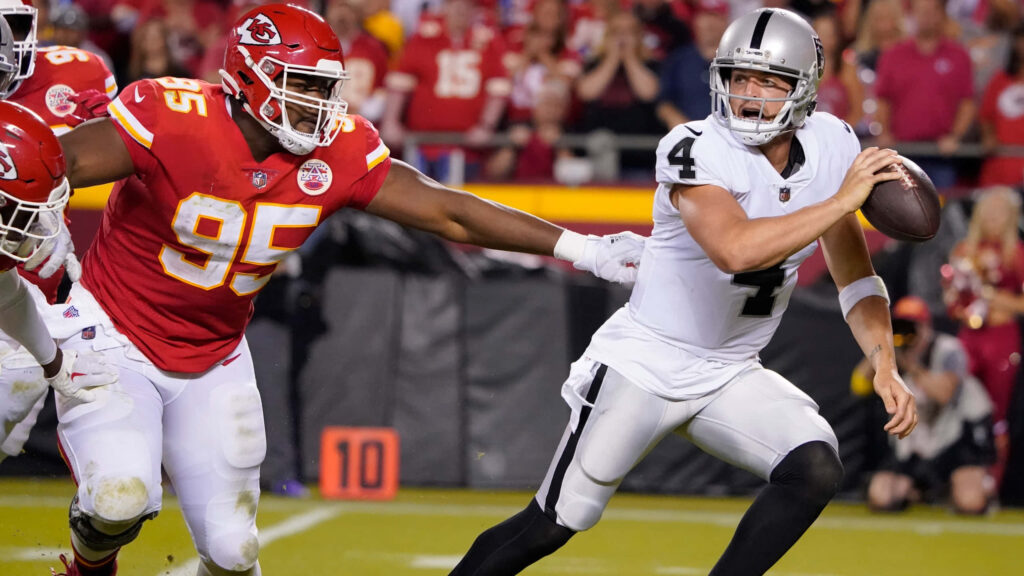 Dynamic Chris Jones Football Game Wallpaper: Intense Tackle Moment