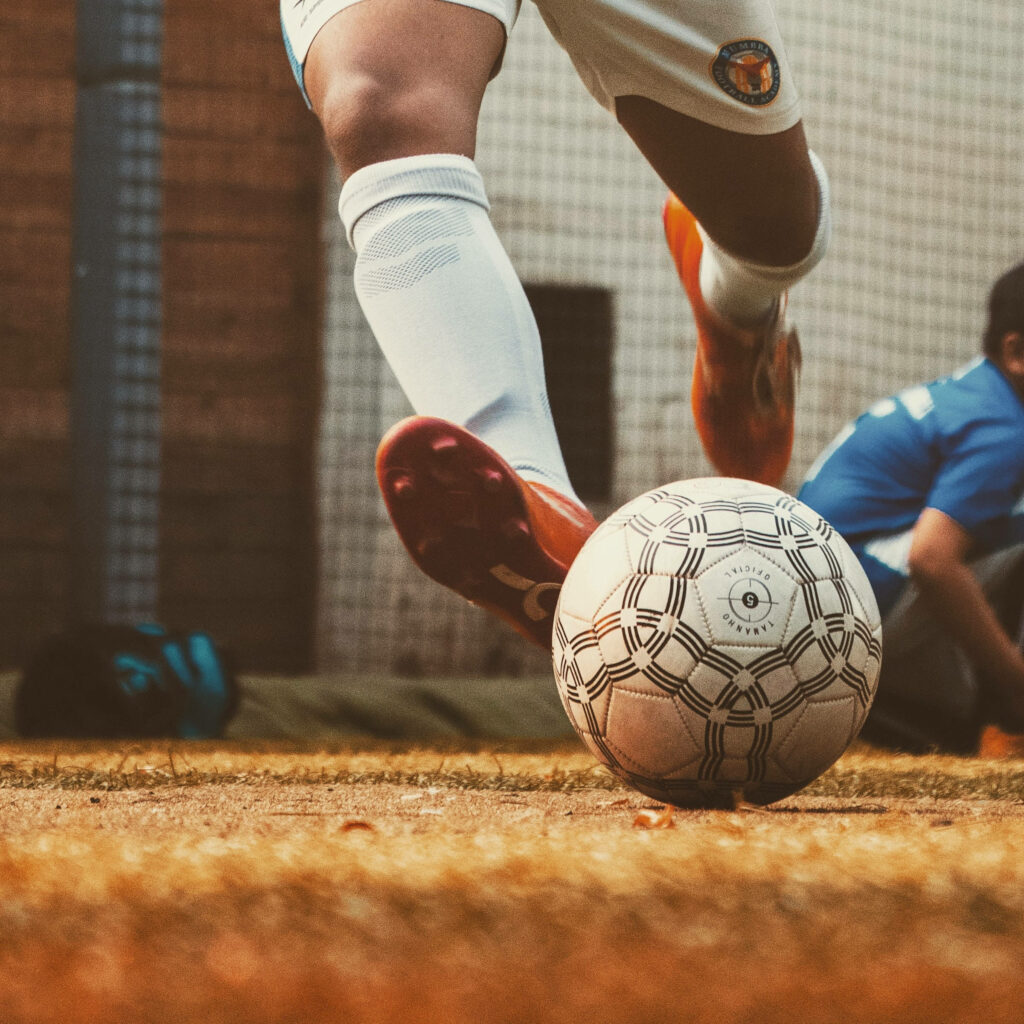 Dynamic Football Wallpaper: Player in Action on the Field