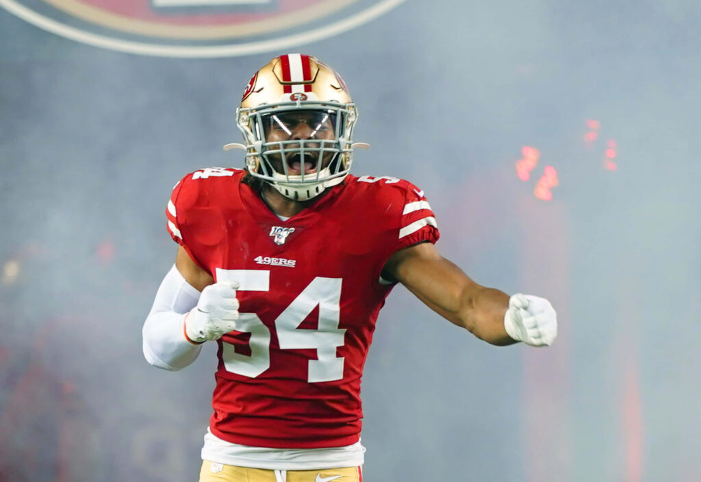 Dynamic Fred Warner Wallpaper: Intense 49ers Action Background