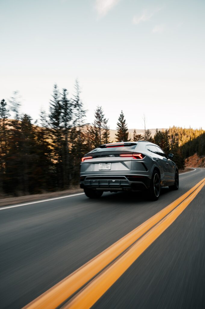 Sleek Gray Lamborghini Urus on Winding Road - Luxury SUV Wallpaper