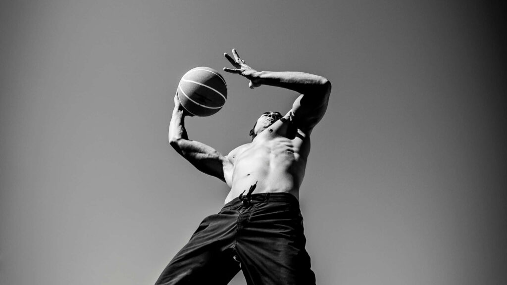Dynamic Grayscale Basketball Player Wallpaper: Athleticism in Action