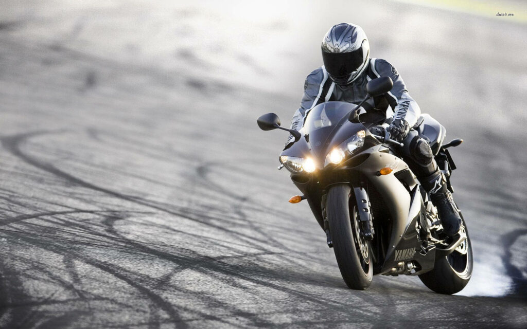 Dynamic HD Wallpaper: Black Motorcycle in Motion on Curving Track