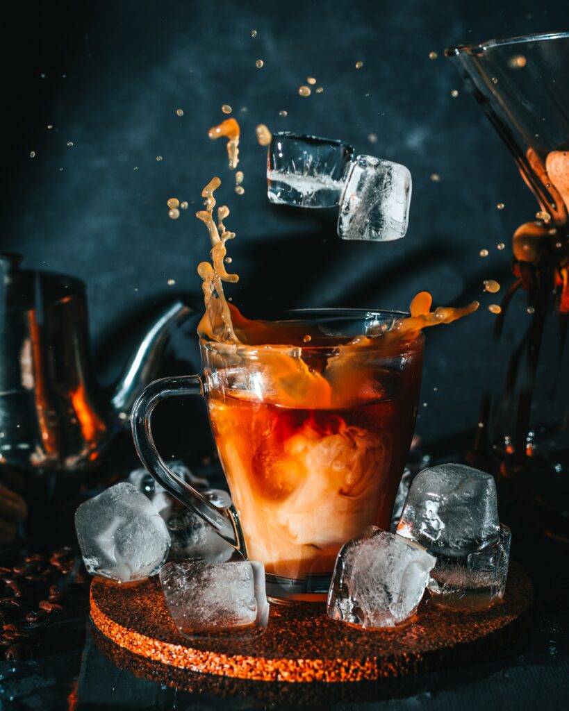 Iced Coffee Splash Wallpaper: Dark Mood with Ice Cubes Background