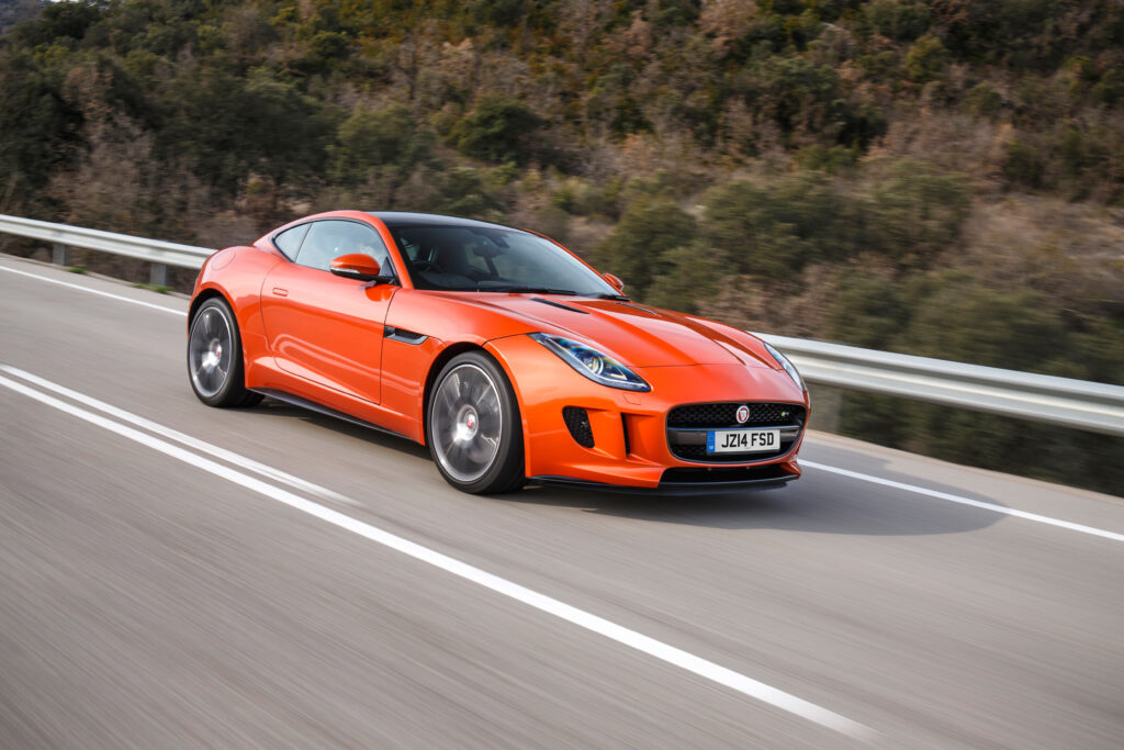 Sleek Jaguar F-Type in Vibrant Orange: Dynamic Wallpaper Background