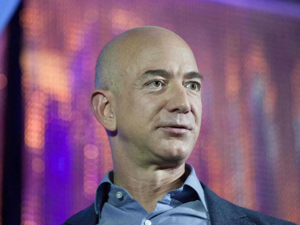 Vibrant Jeff Bezos Wallpaper Against Sparkly Background
