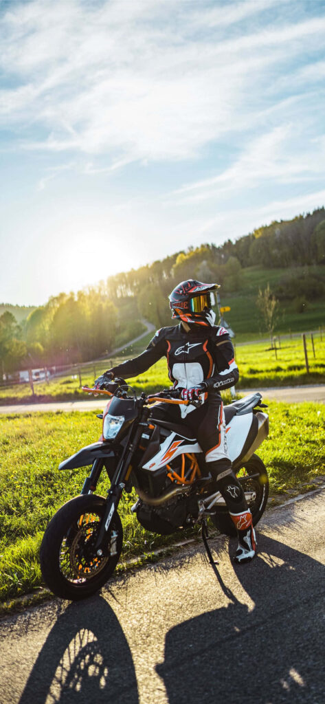 Vibrant KTM Dirt Bike Rider Wallpaper in Scenic Countryside