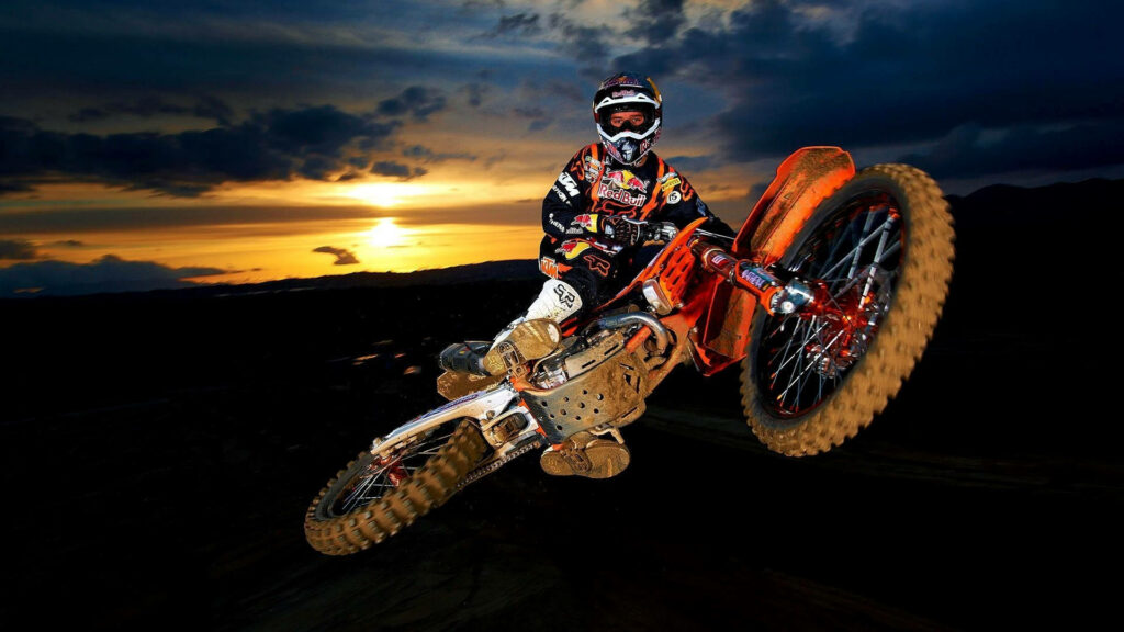 Dynamic KTM Motocross Wallpaper: Adrenaline Stunt at Sunset