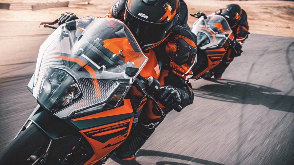 Dynamic KTM RC 200 Racing Wallpaper: Speed on Curved Track