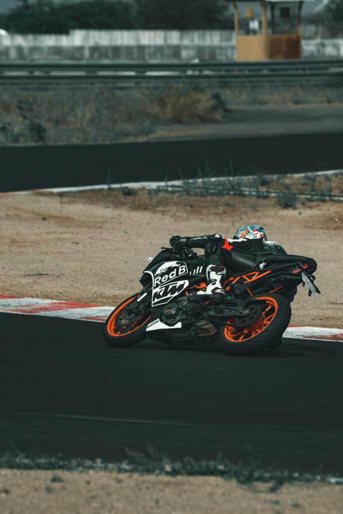 Dynamic KTM RC 390 Motorcycle Wallpaper: Rider Carving a Track Turn