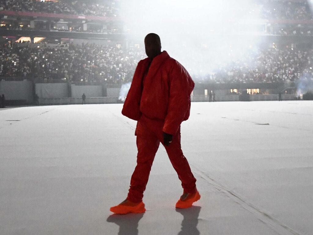 Kanye West Donda Era Wallpaper: Artistic Red Outfit in Stadium Mist