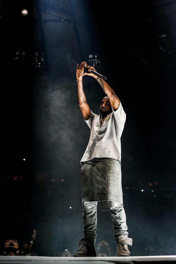Kanye West Dynamic Wallpaper: Stage Performance with Dramatic Lighting