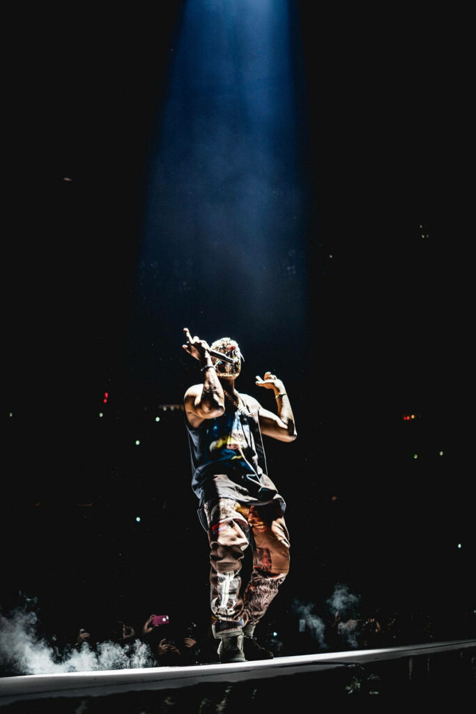Kanye West Stage Performance Dynamic Wallpaper - Energized Crowd Background