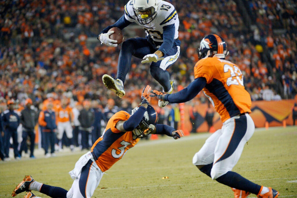 Dynamic Keenan Allen Football Wallpaper: Leaping Over Defenders