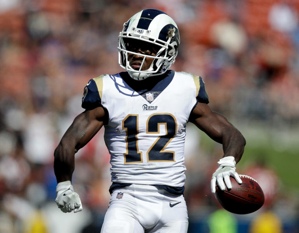 Los Angeles Rams wide receiver Brandin Cooks in action wearing number 12 jersey blue gold background Wallpaper