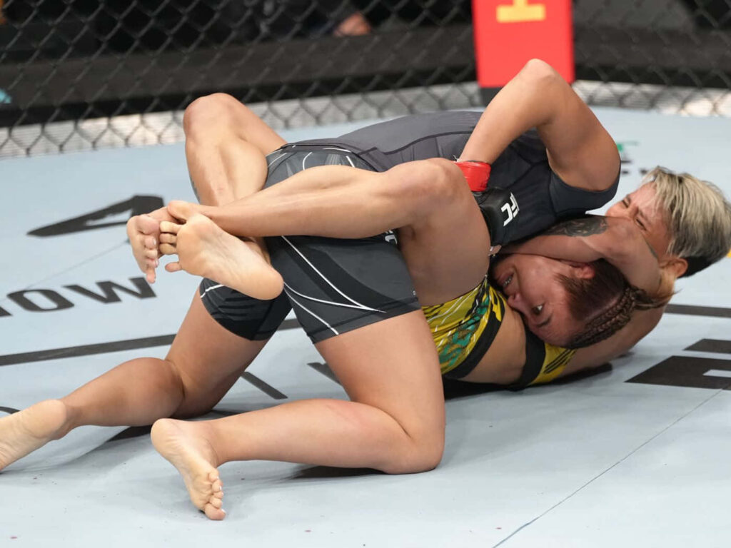 Dynamic MMA Fighters Wallpaper: Intense Ground Combat Background