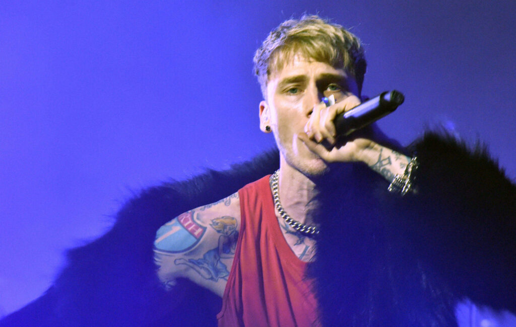 Vibrant Machine Gun Kelly Wallpaper: Energetic Performance Style
