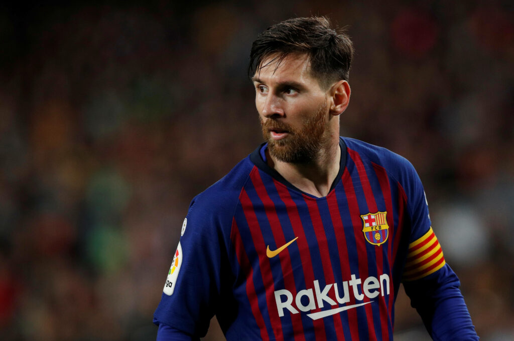 Fearless FC Barcelona Icon Messi Strikes a Pose in Vibrant 2020 Rakuten Jersey Amid Tempest of Action on the Pitch Wallpaper