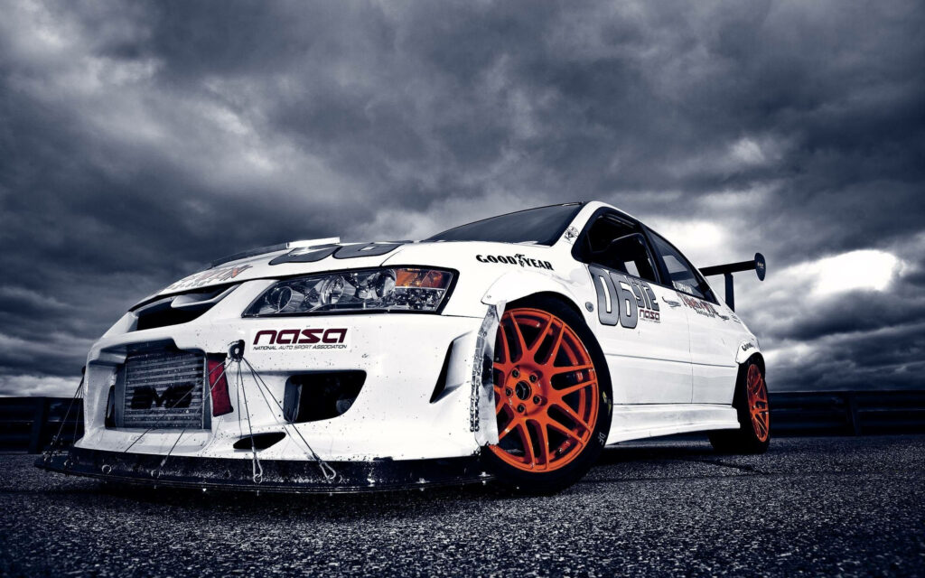 Dynamic Mitsubishi Lancer Wallpaper with Bold Orange Wheels