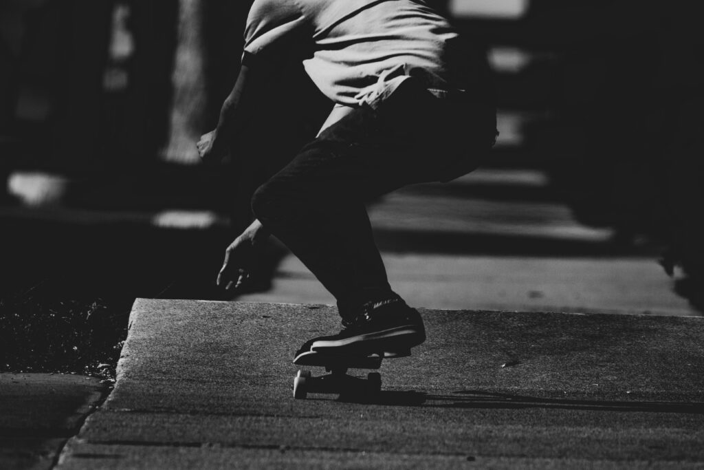 Dynamic Monochrome Skateboarder on Dark Asphalt Wallpaper