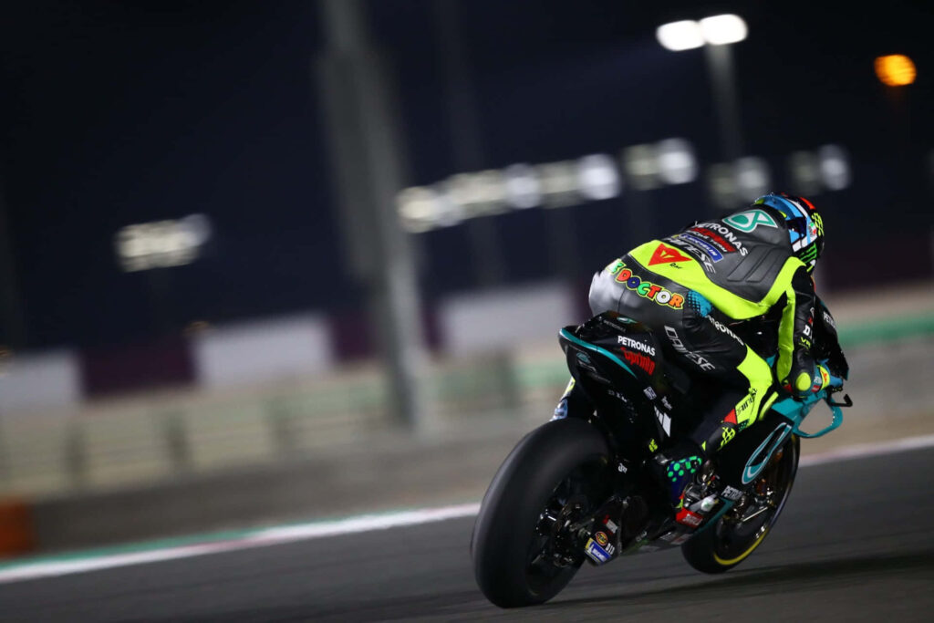 Vibrant VR46 Racing Team Wallpaper: MotoGP Rider in Racing Action