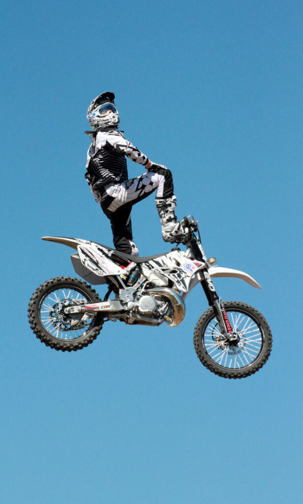Dynamic Motocross Rider Mid-Air Stunt Wallpaper Background