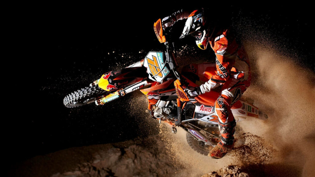 Dynamic Motocross Wallpaper: Rider Stunt Thrill in Extreme Sports
